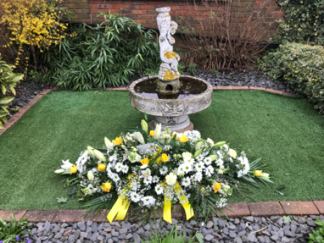 yellow and white casket spray