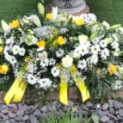 yellow and white casket spray